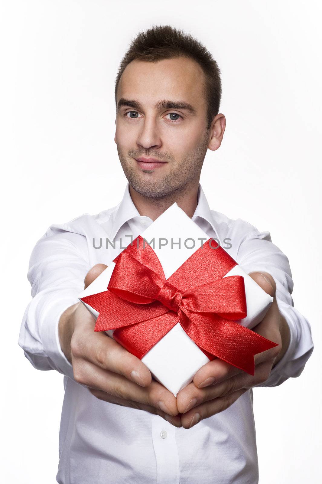 young handsome male giving a gift, over white background
