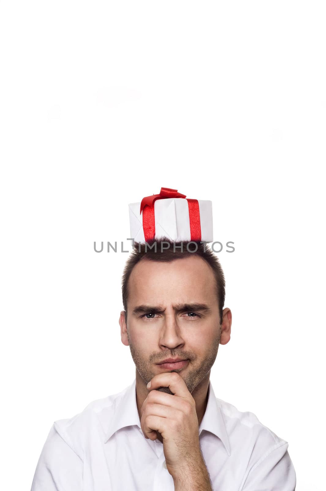 young handsome man with a gift on his head, over white background