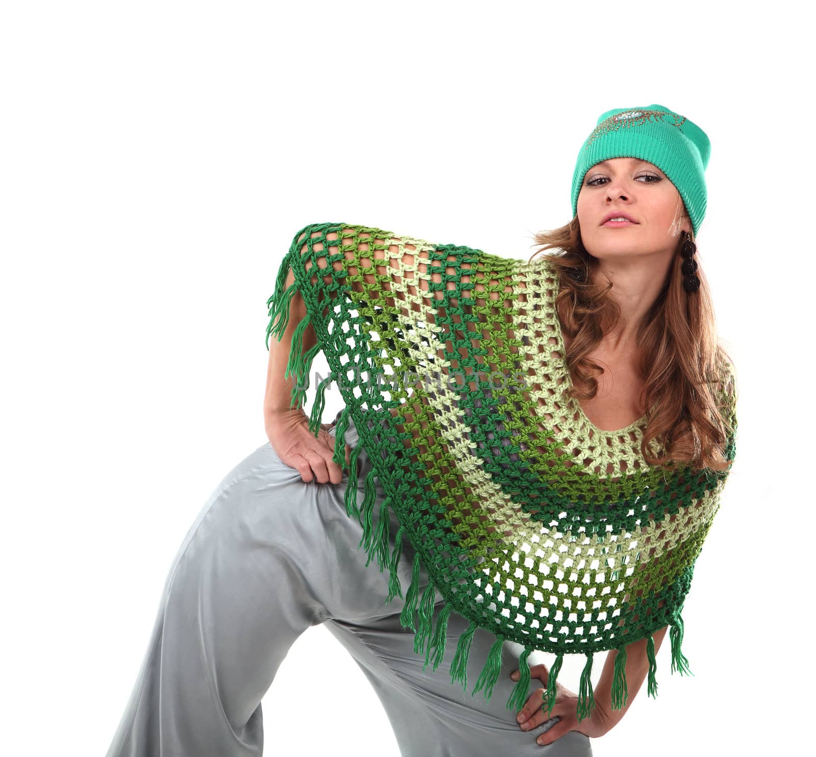 Girl in a green knit poncho on tne white background
