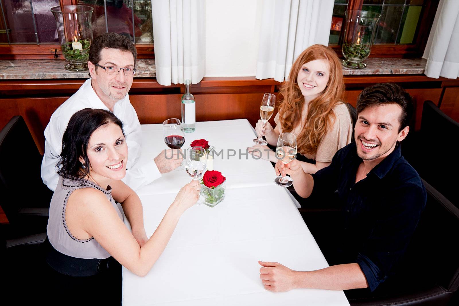 smiling happy people in restaurant drinking talking having fun 