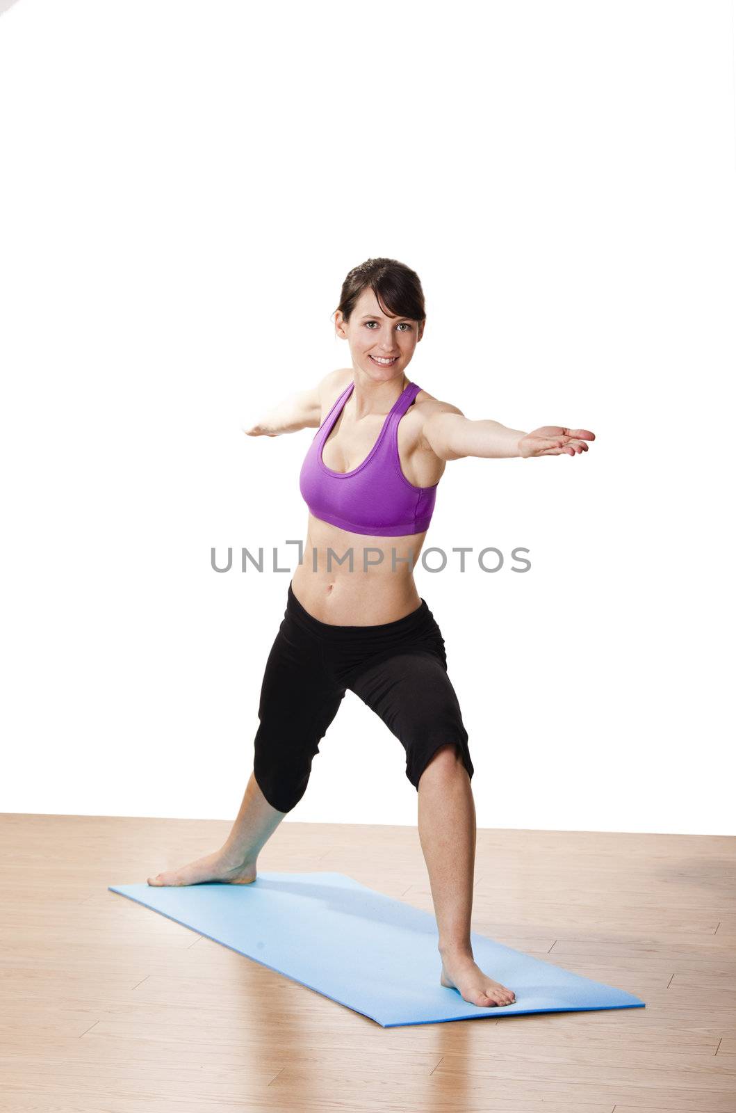 Beautiful and athletic young woman doing yoga exercises