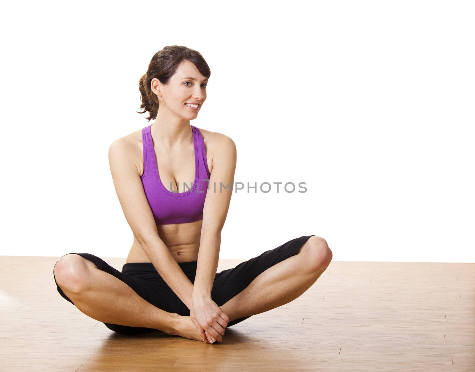 Beautiful and athletic young woman doing yoga exercises