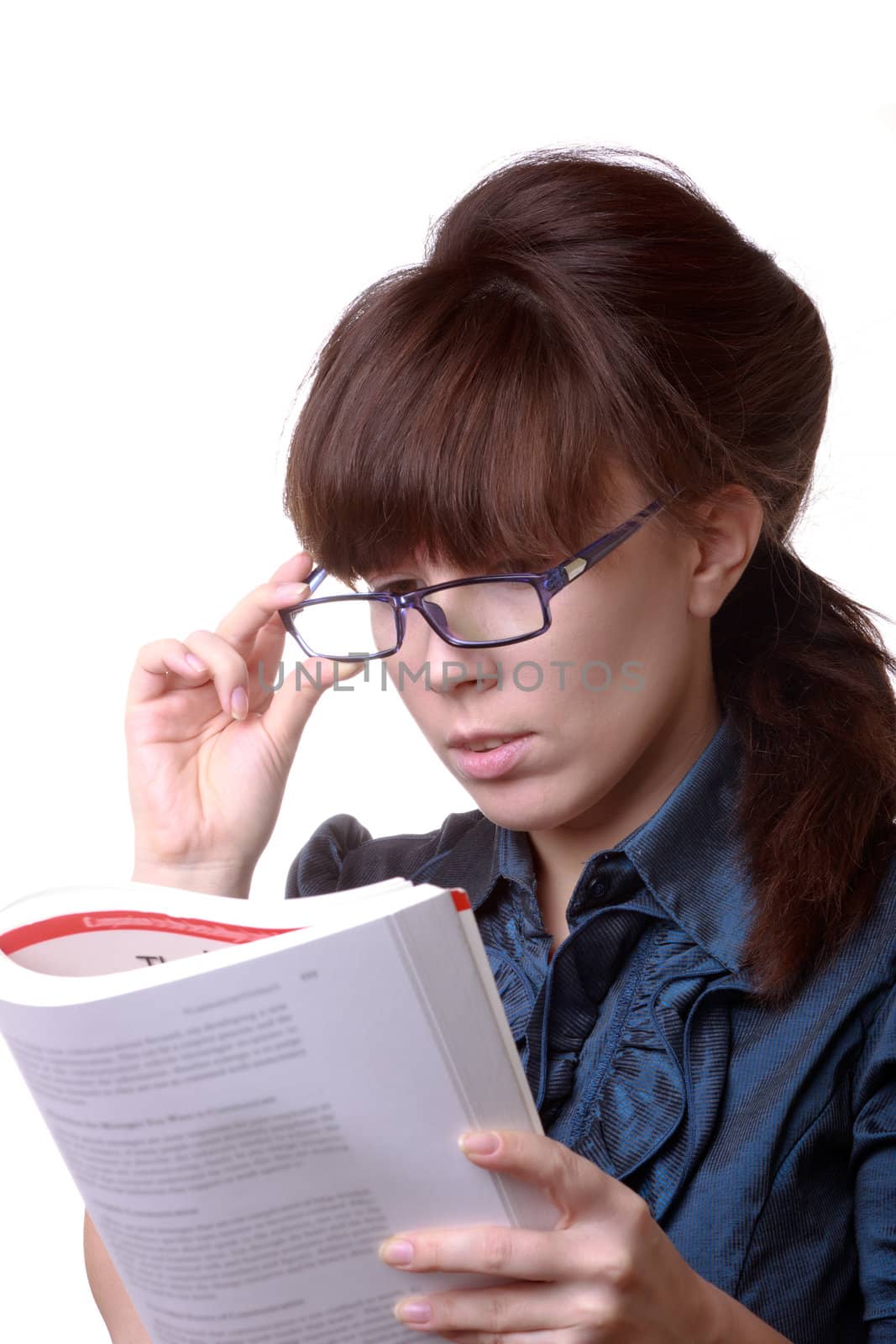 Portrait of young alluring brunette woman, holding book on white background