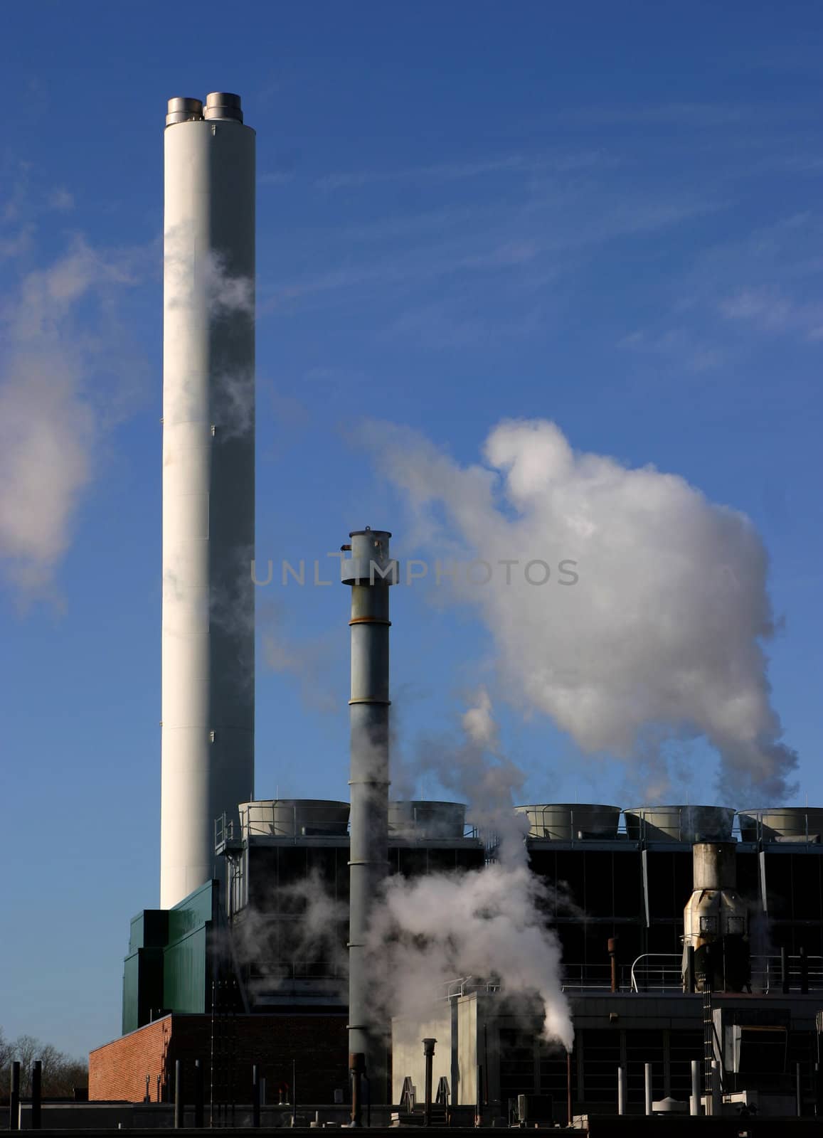 Evaporations coolers & steam stacks in front of a blue sky