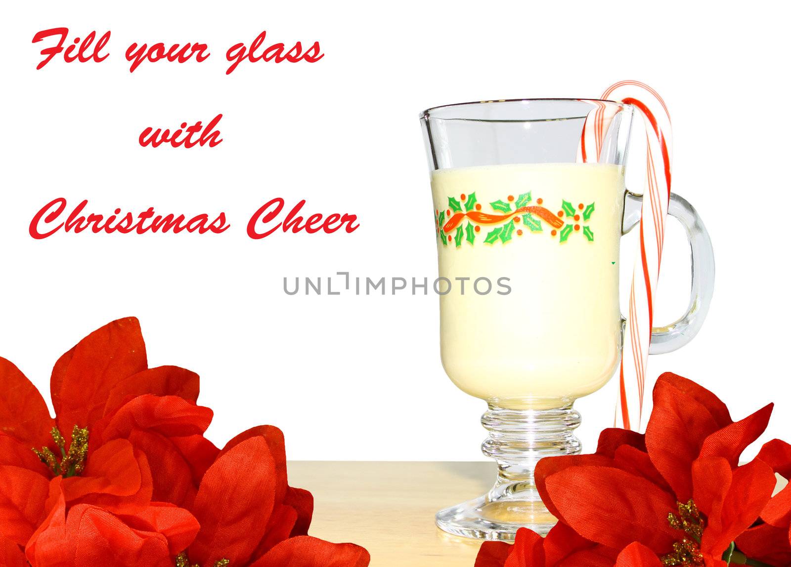 A glass of Christmas eggnog with a candy cane on a table with poinsettias and a white background