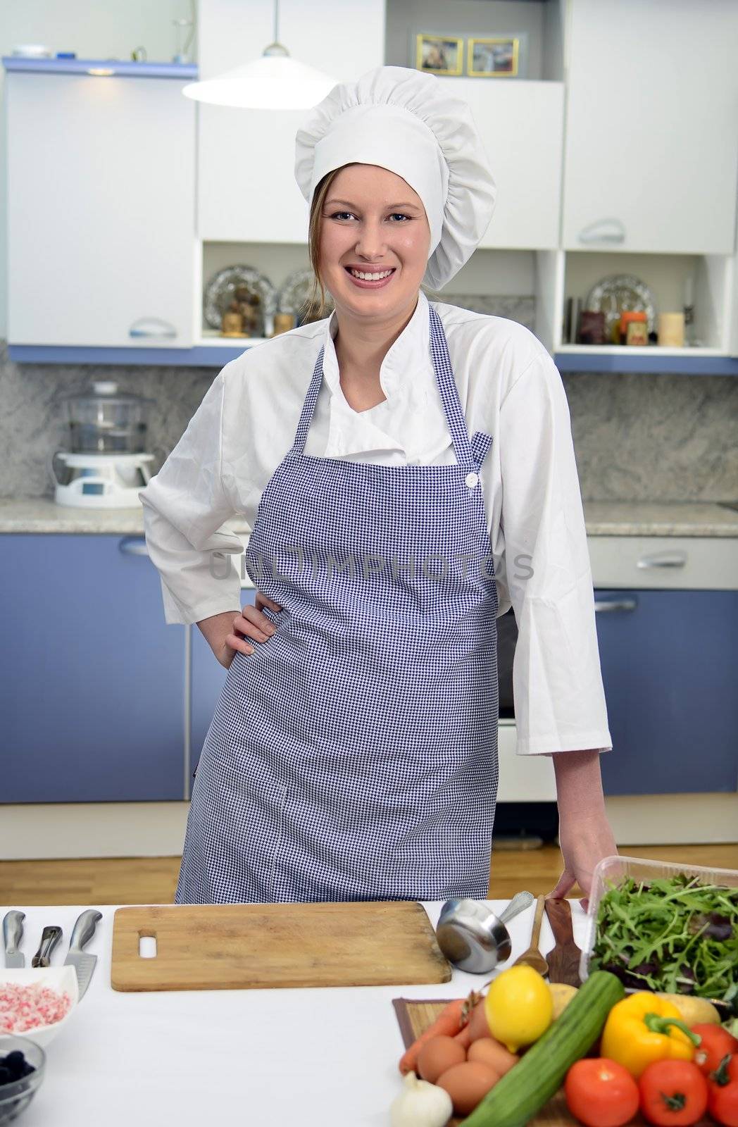 Smiling chief cook in the kitchen