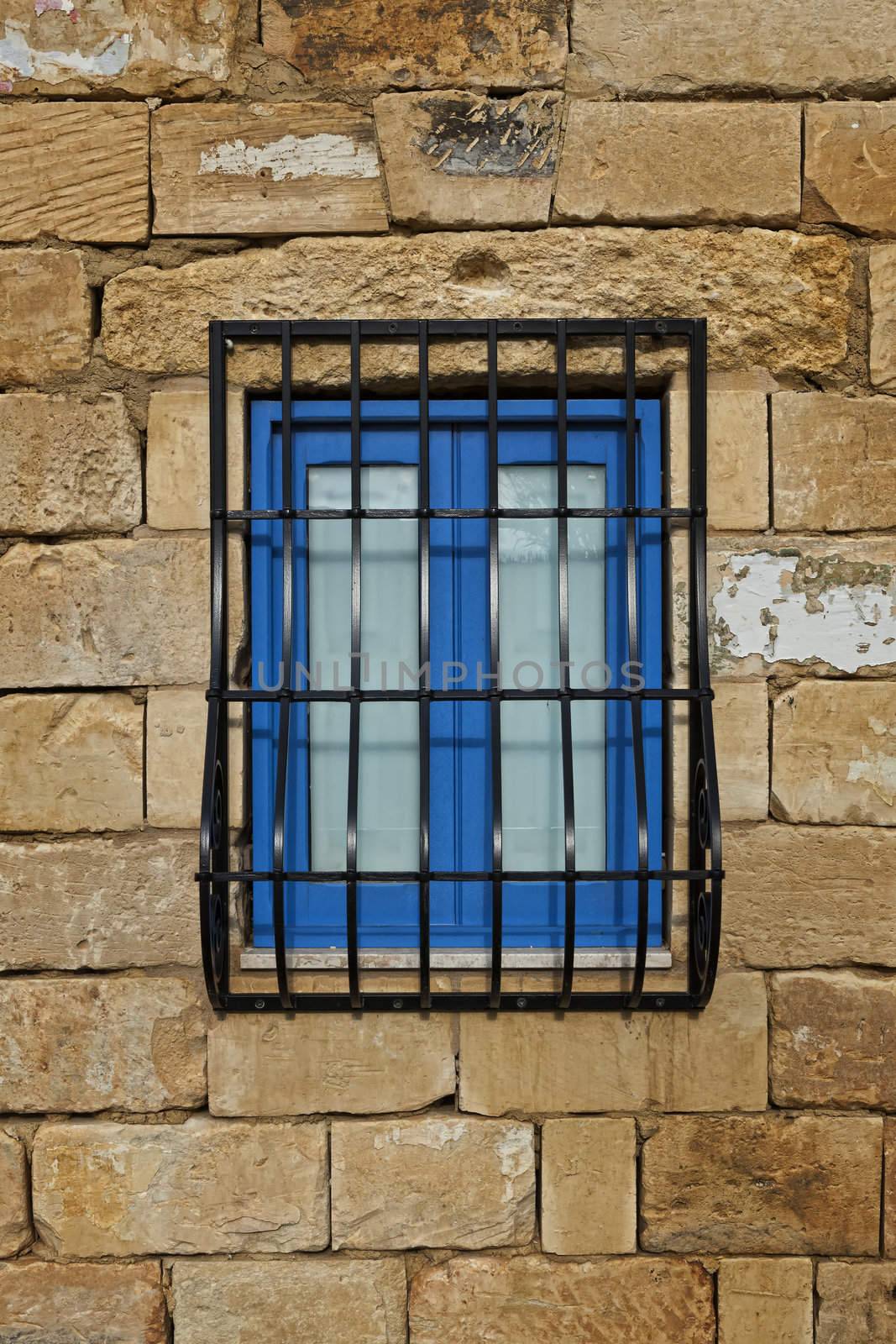A cute rustic window set in limestone blocks on a typical Malta farmhouse