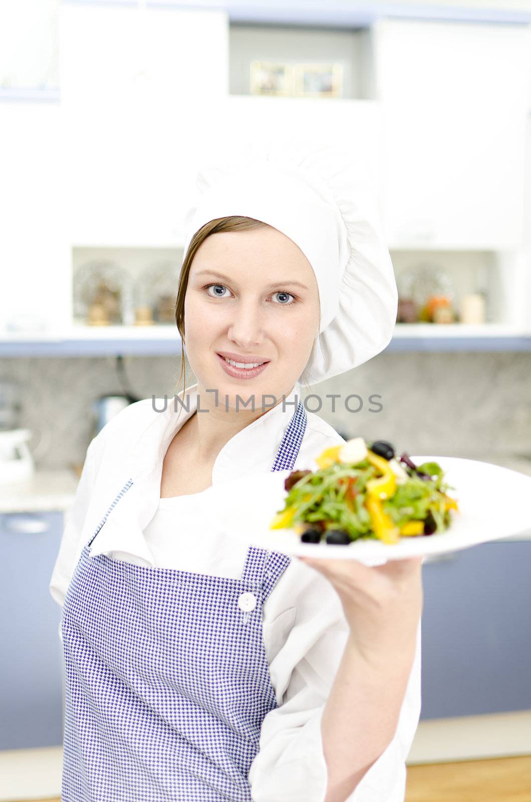 Pretty cook chief holding salad