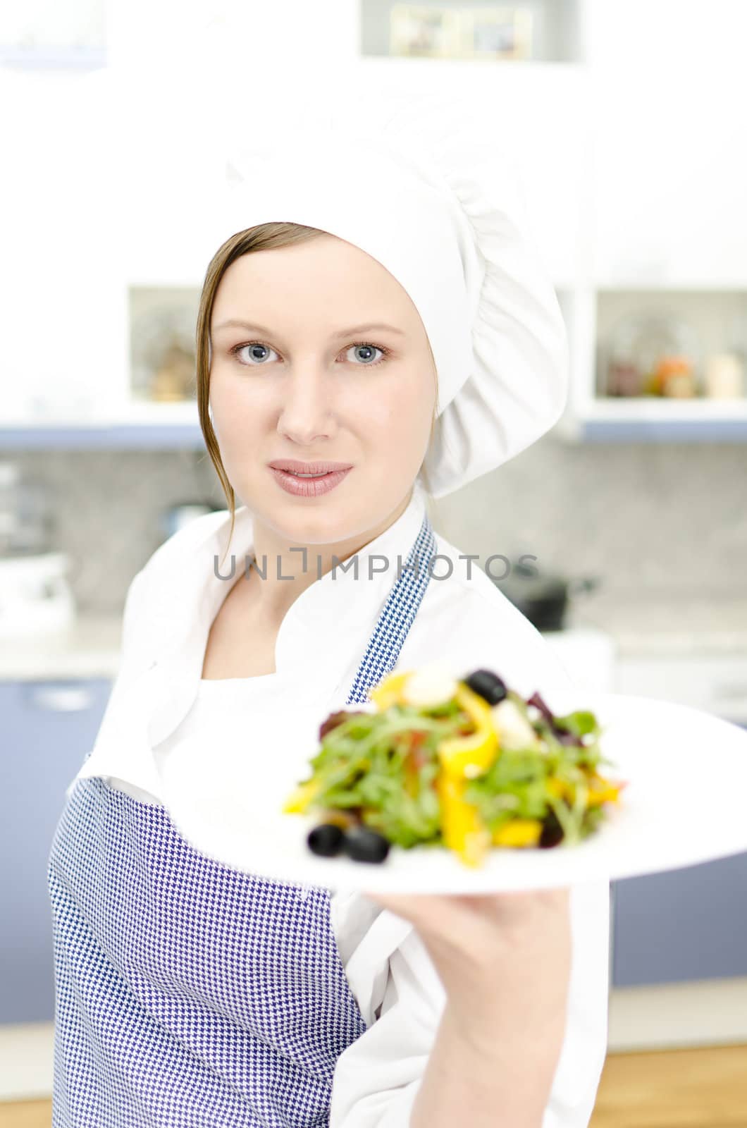 Pretty cook chief holding salad
