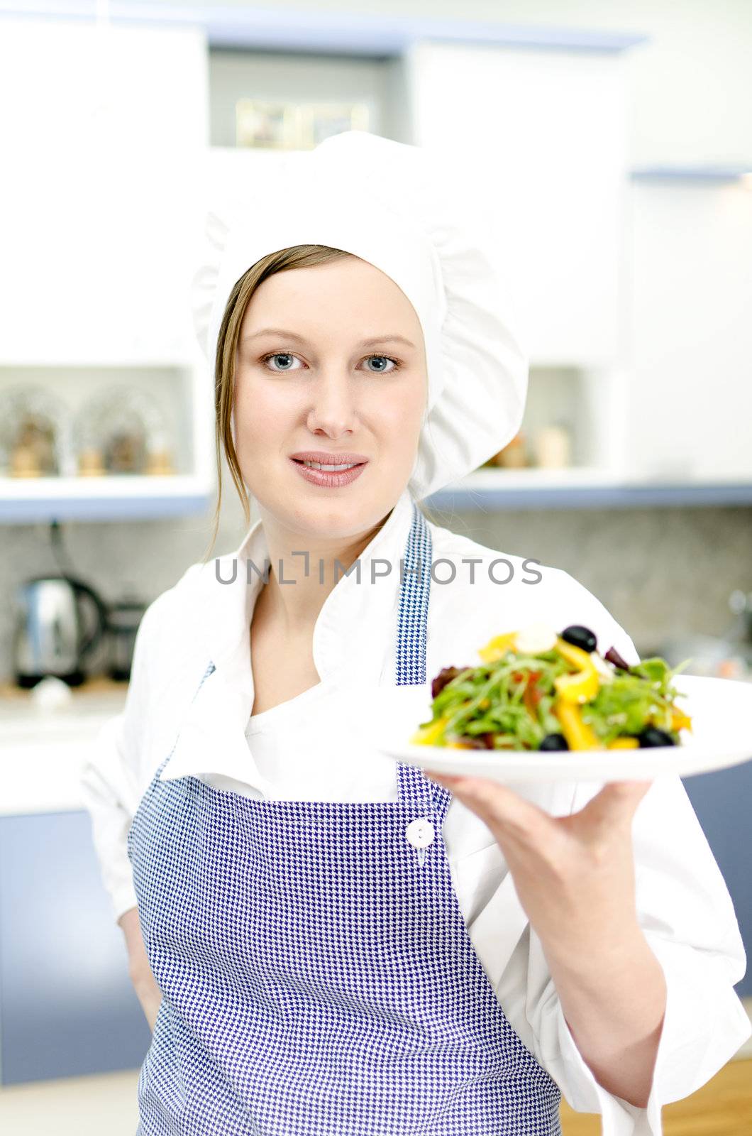 Pretty cook chief holding salad