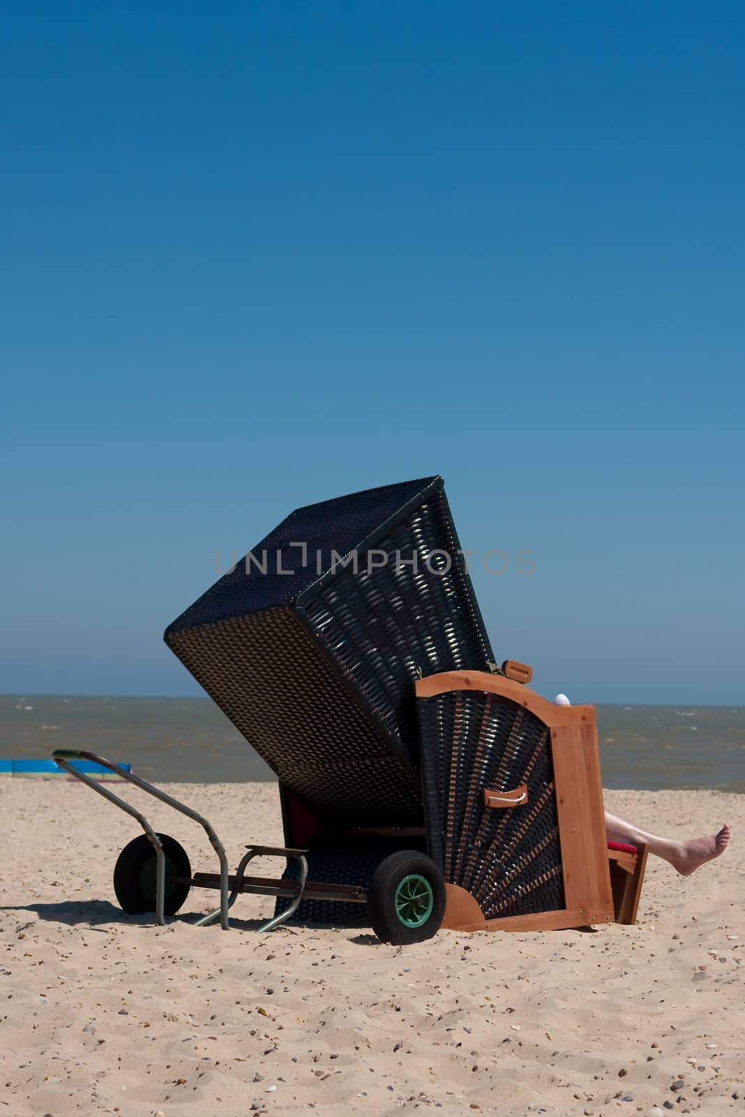 Interesting wooden deckchair on a sunny beach
