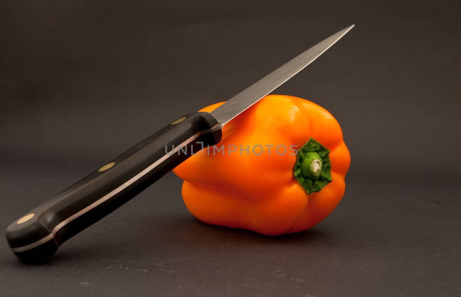 orange bell pepper and knife