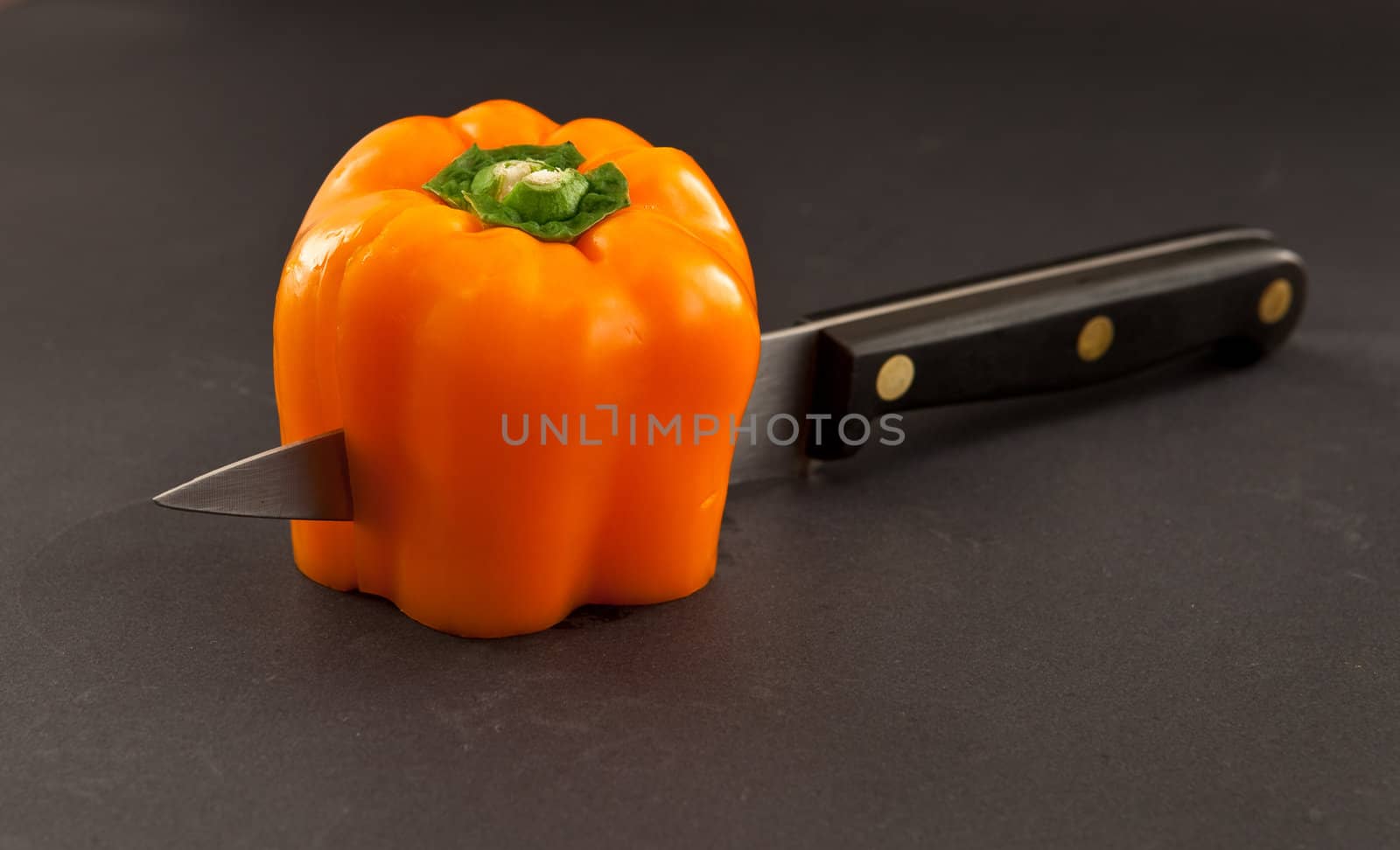 orange bell pepper and knife