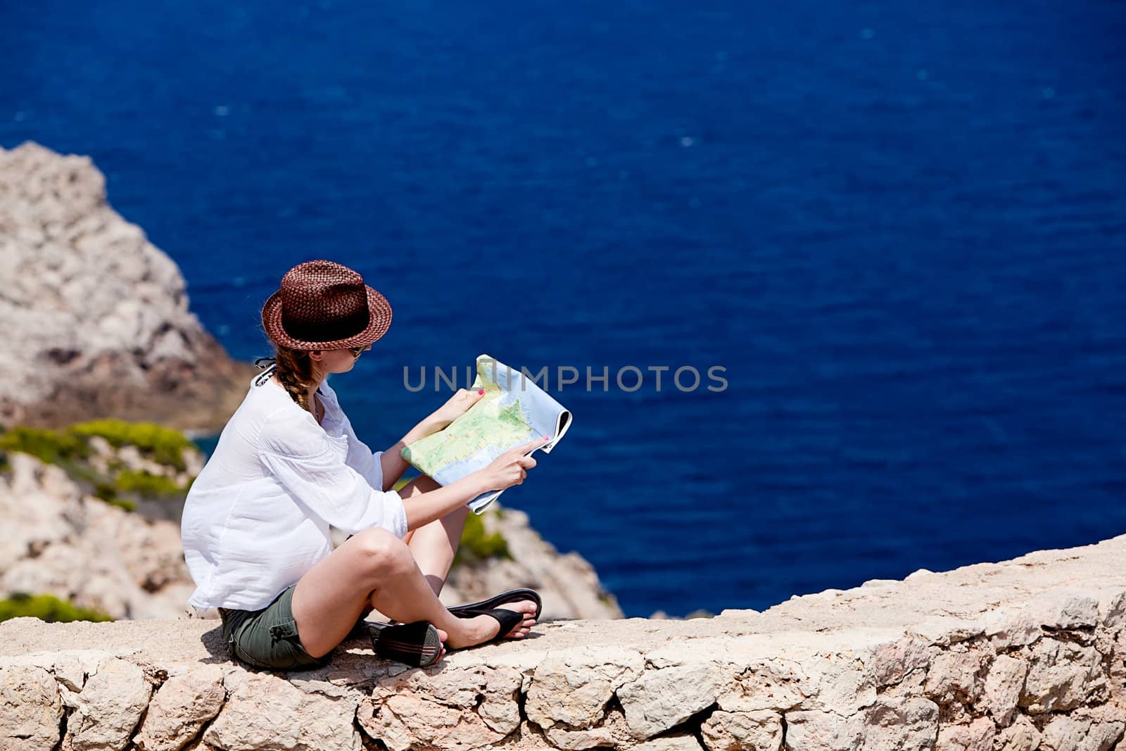 young attractive woman with land map in summer holiday outdoor
