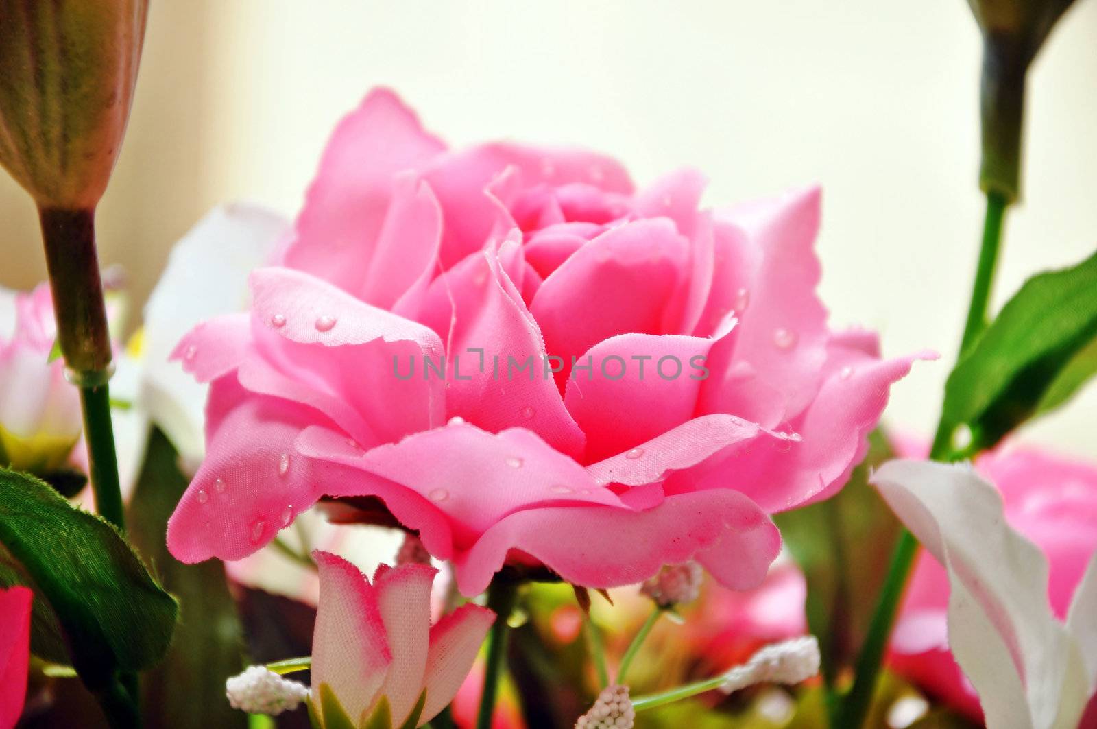 Artificial flowers are imitations of natural flowering plants, used for commercial or residential decoration.