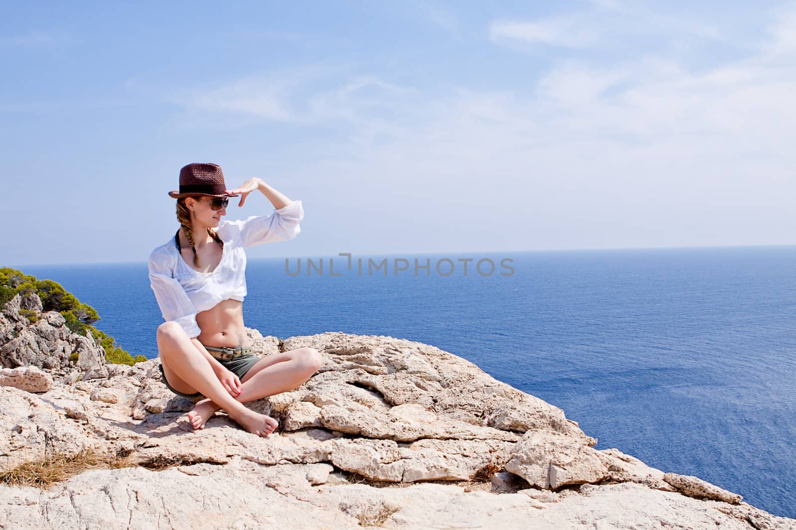young girl with brown hat in summer holiday outside in nature