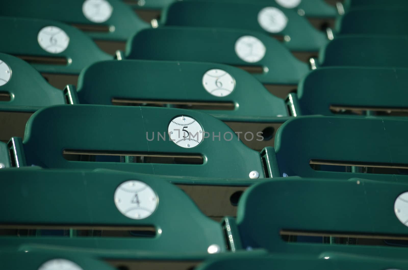 Seats at a baseball stadium ready for fans to sit in.