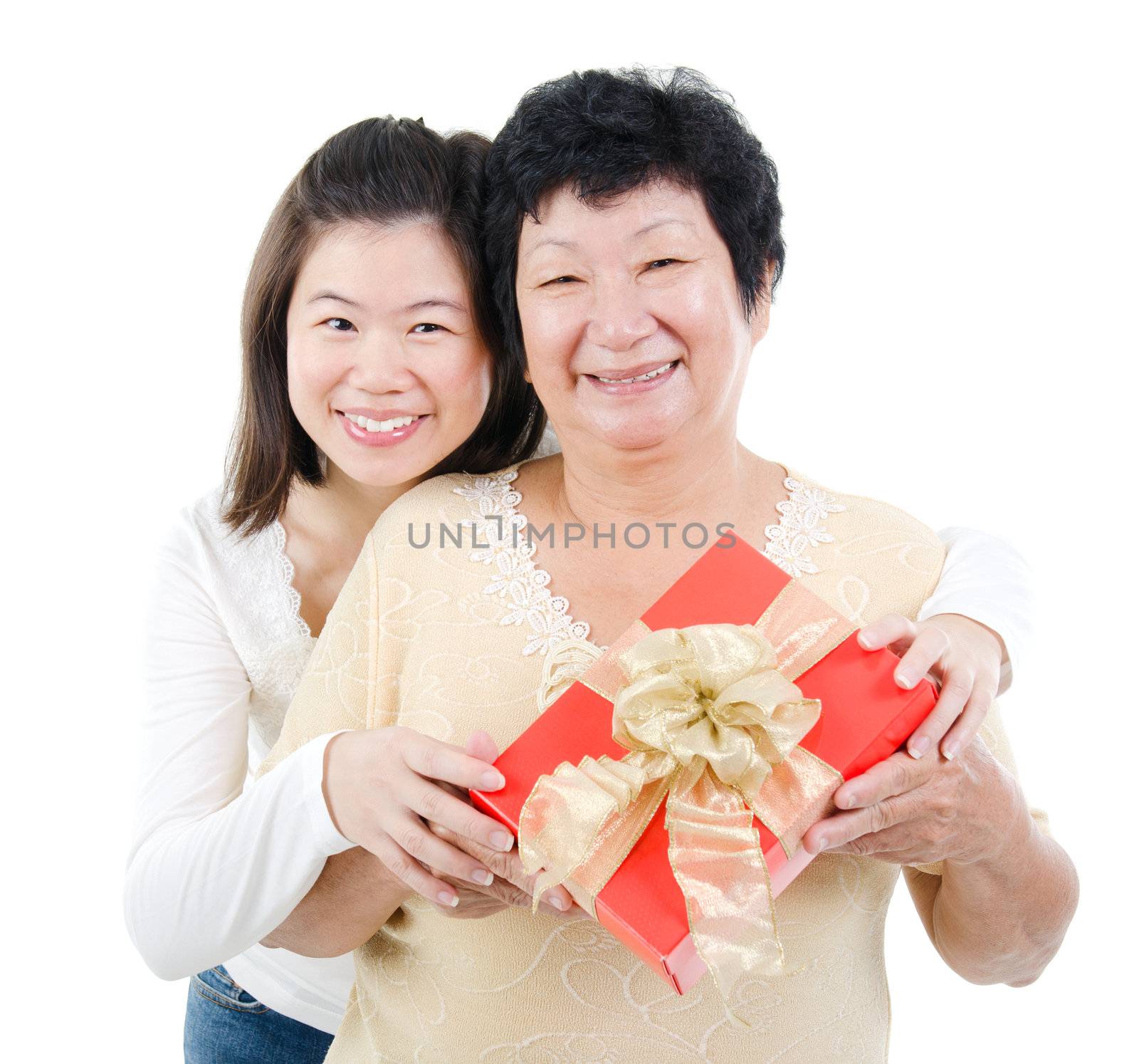 Asian parent and adult offpring holding a gift box smiling, isolated on white background.