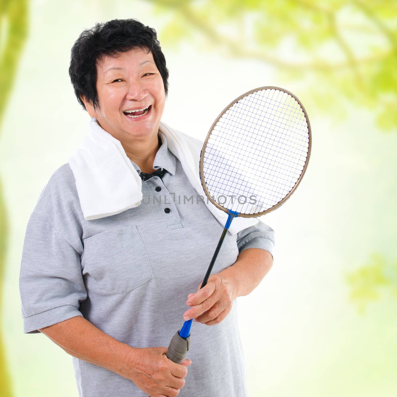 Asian senior woman healthy lifestyle. Happy Asian grandparent holding badminton racket