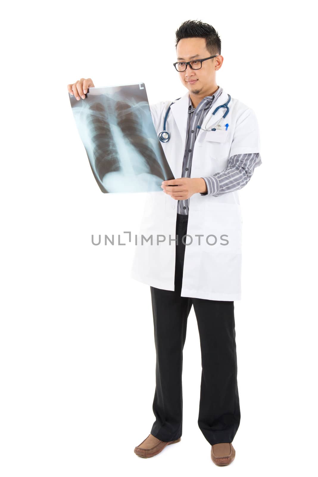 Full body Asian medical doctor checking on x-ray image standing isolated white background