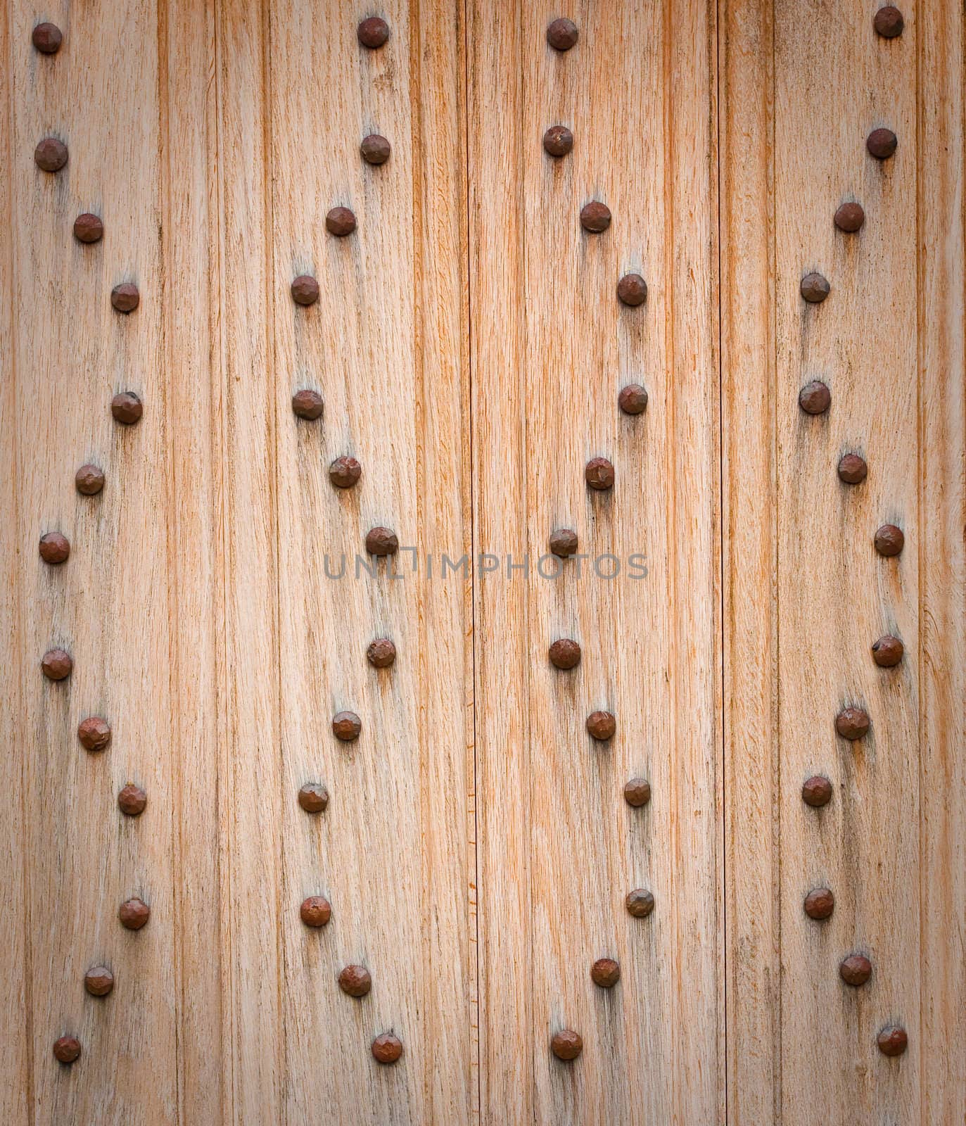 studded wooden door as background