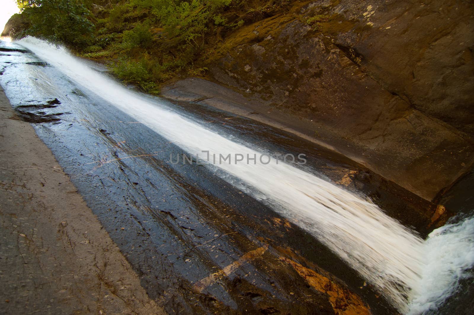 Mountain creek falling like a waterfall in a park