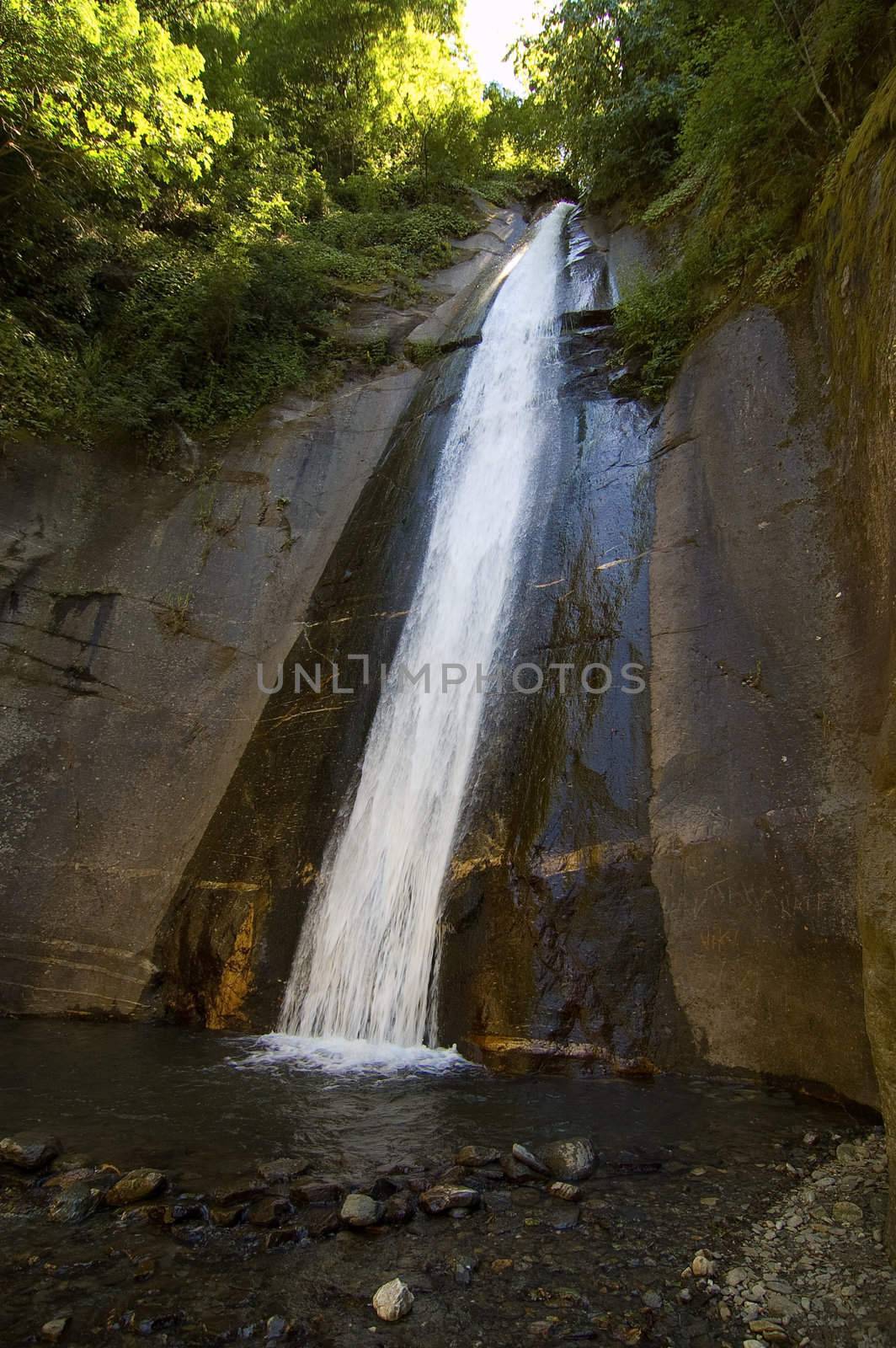 Pure clean water in motion outdoor on wet rocks