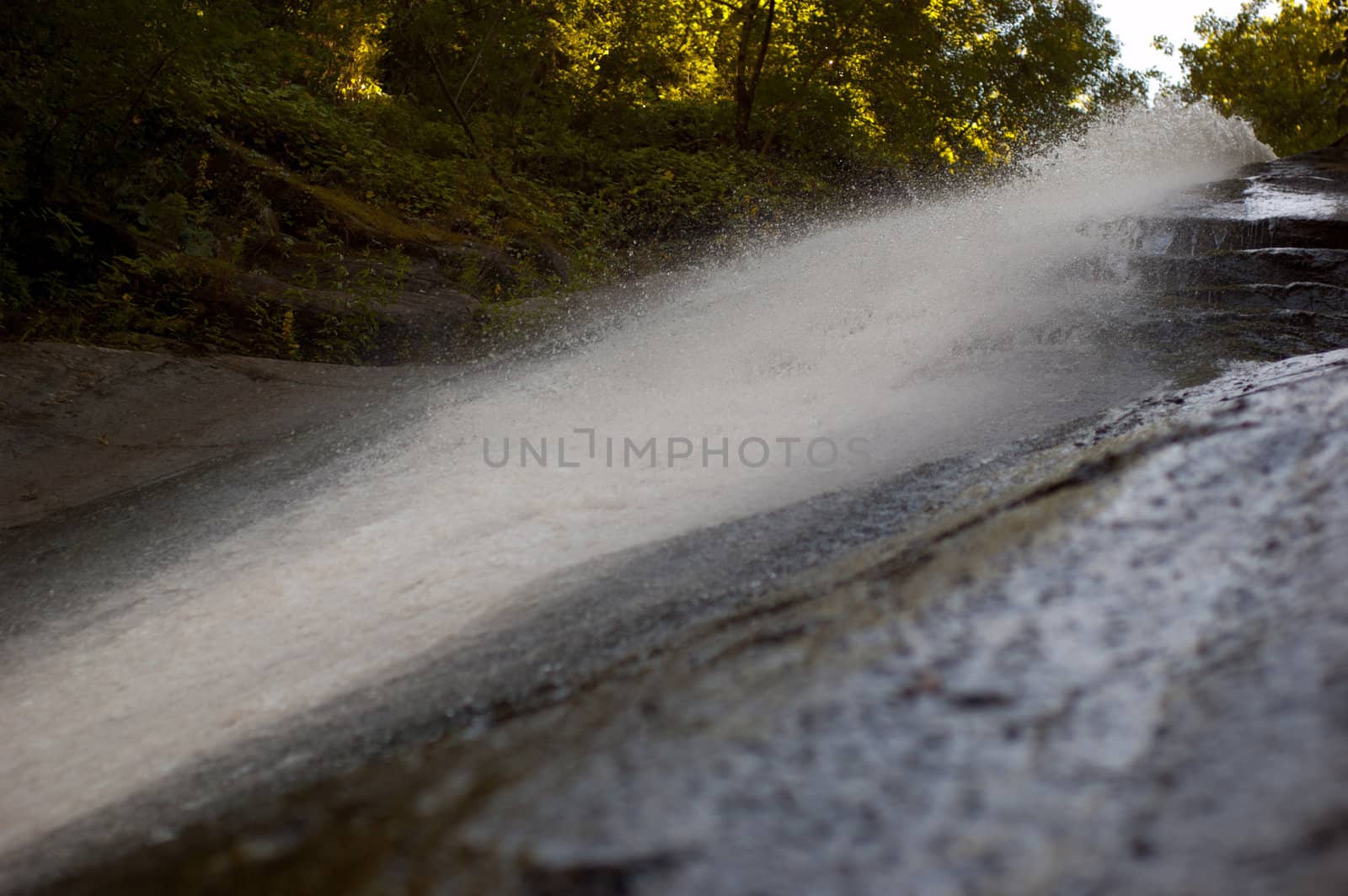 Small waterfall in a park folowing nearby