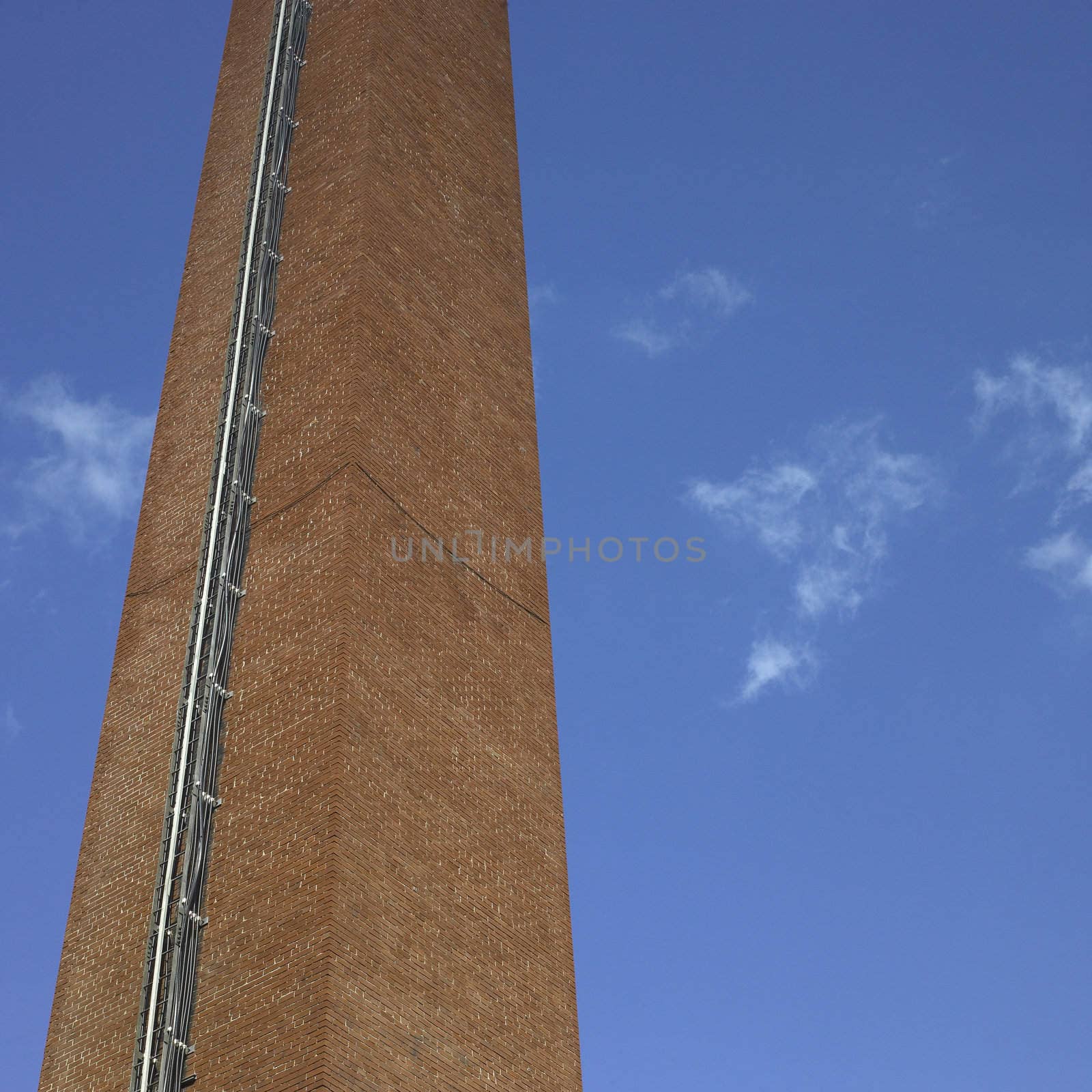 Brick industrial chimney and blue sky