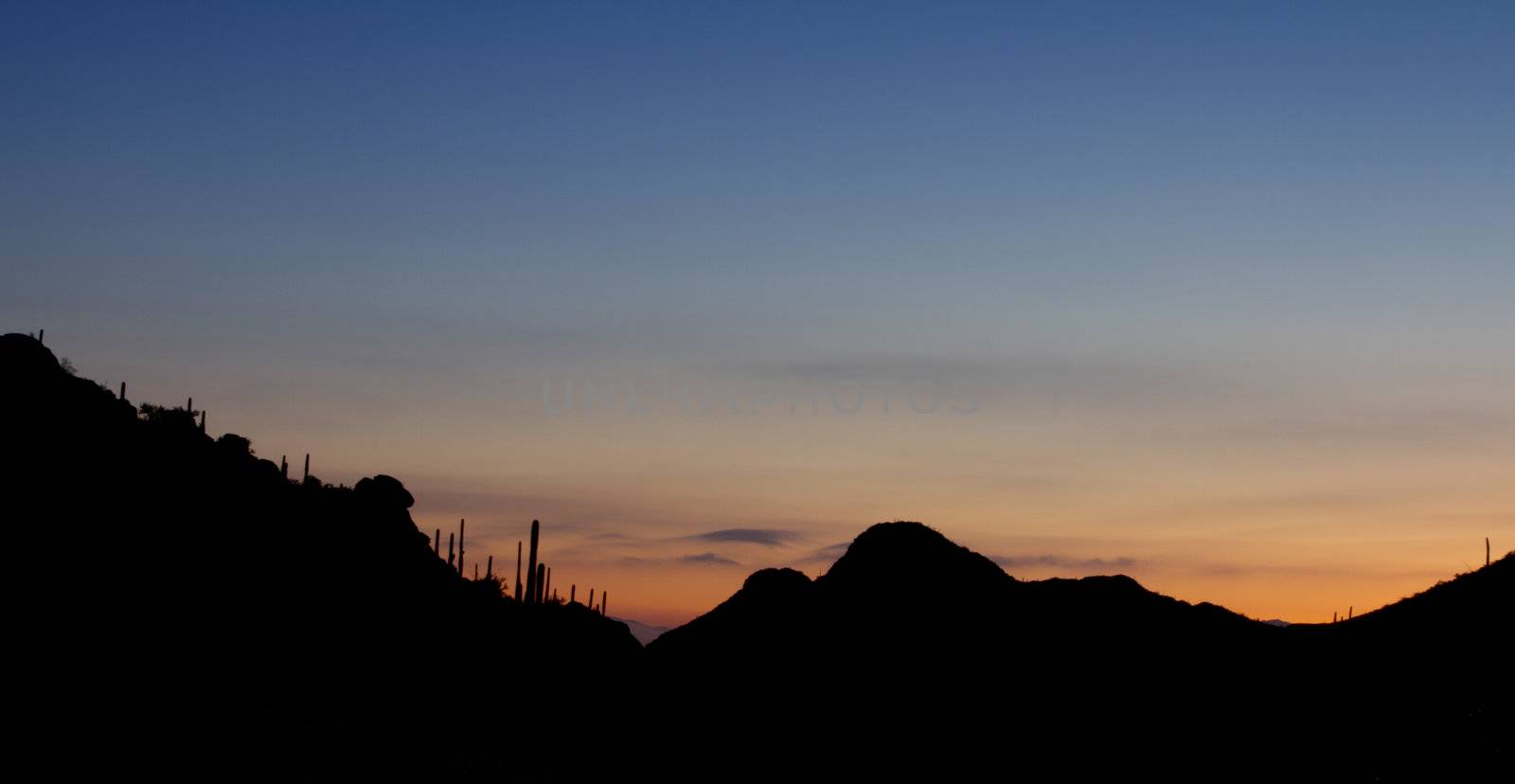 Sunrise at Gates Pass in Tucson Mountain Park, looking back toward city of Tucson, Arizona; copy space above;
