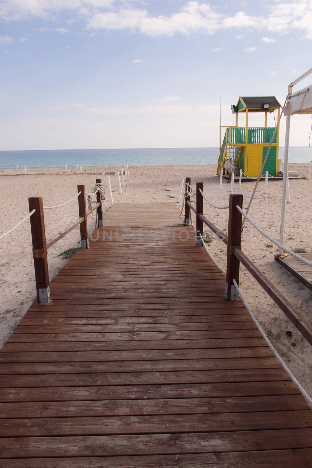 wooden walkway on the white sand