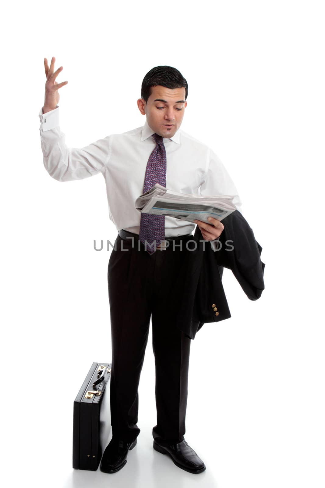 A smartly dressed businessman reading the newspaper and throwing up his hands in disbelief.  Parts have been intentionally blurred.  White background.