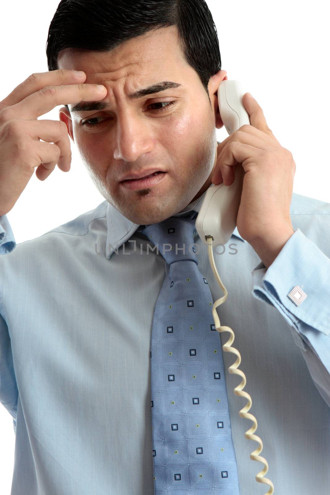 Stressed, depressed, worried or upset business man using telephone.  Useful for many situations.  White background.