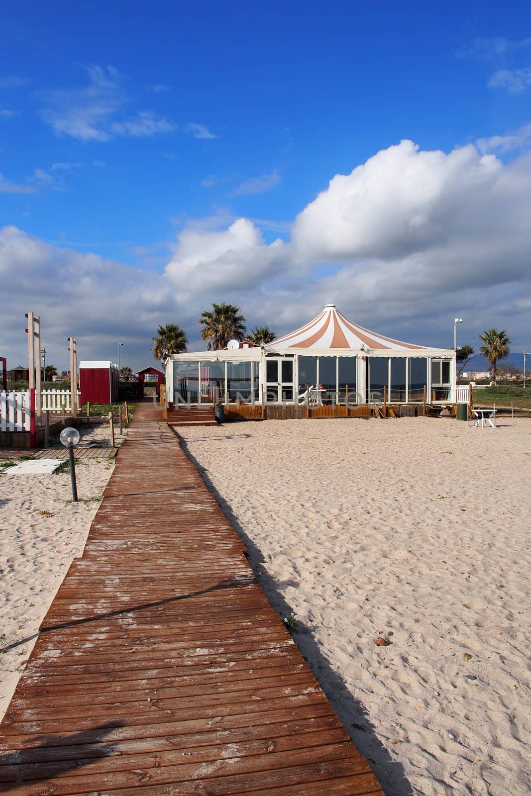 wooden walkway on the white sand