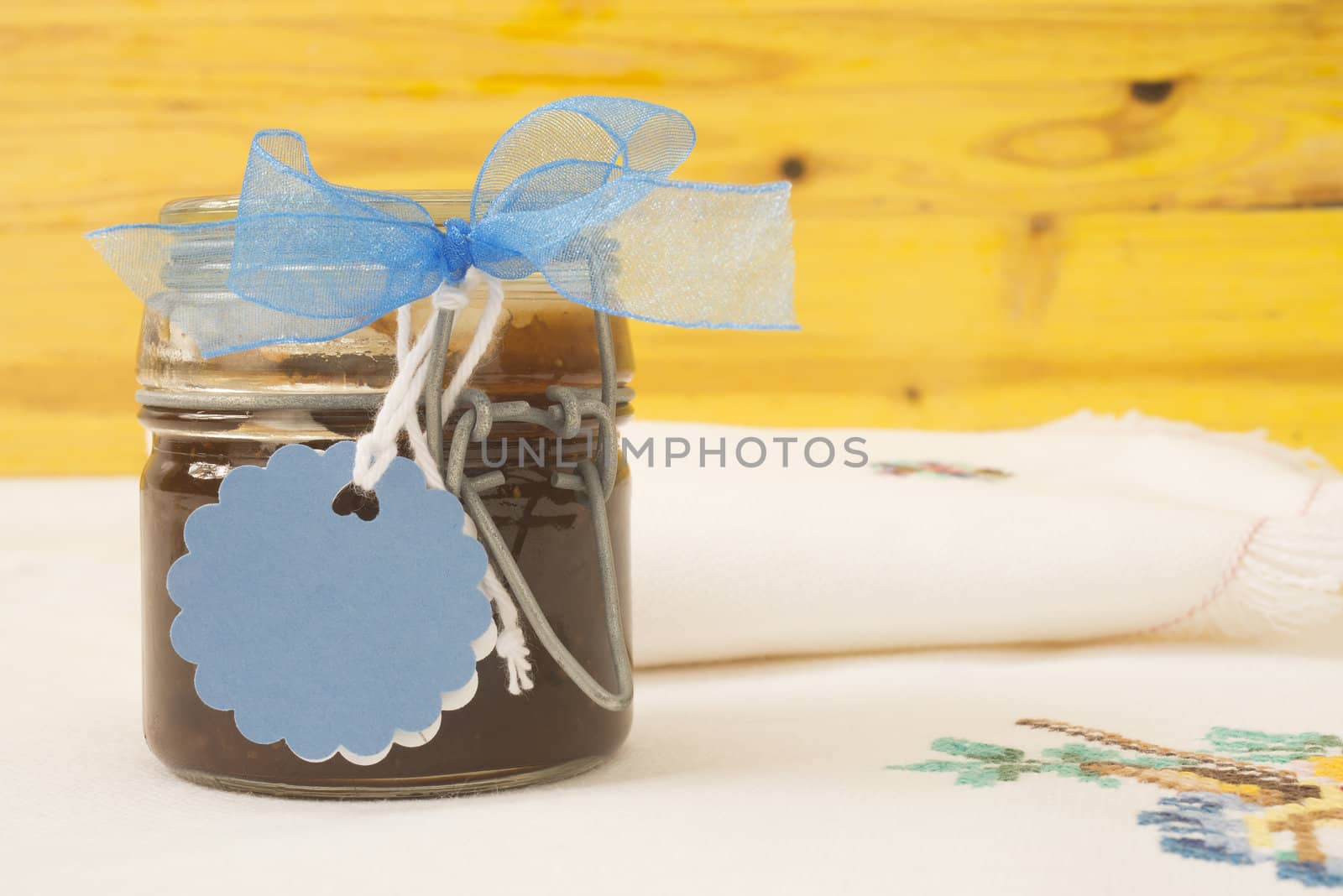 jam jar with blank label for text, tablecloth and napkin