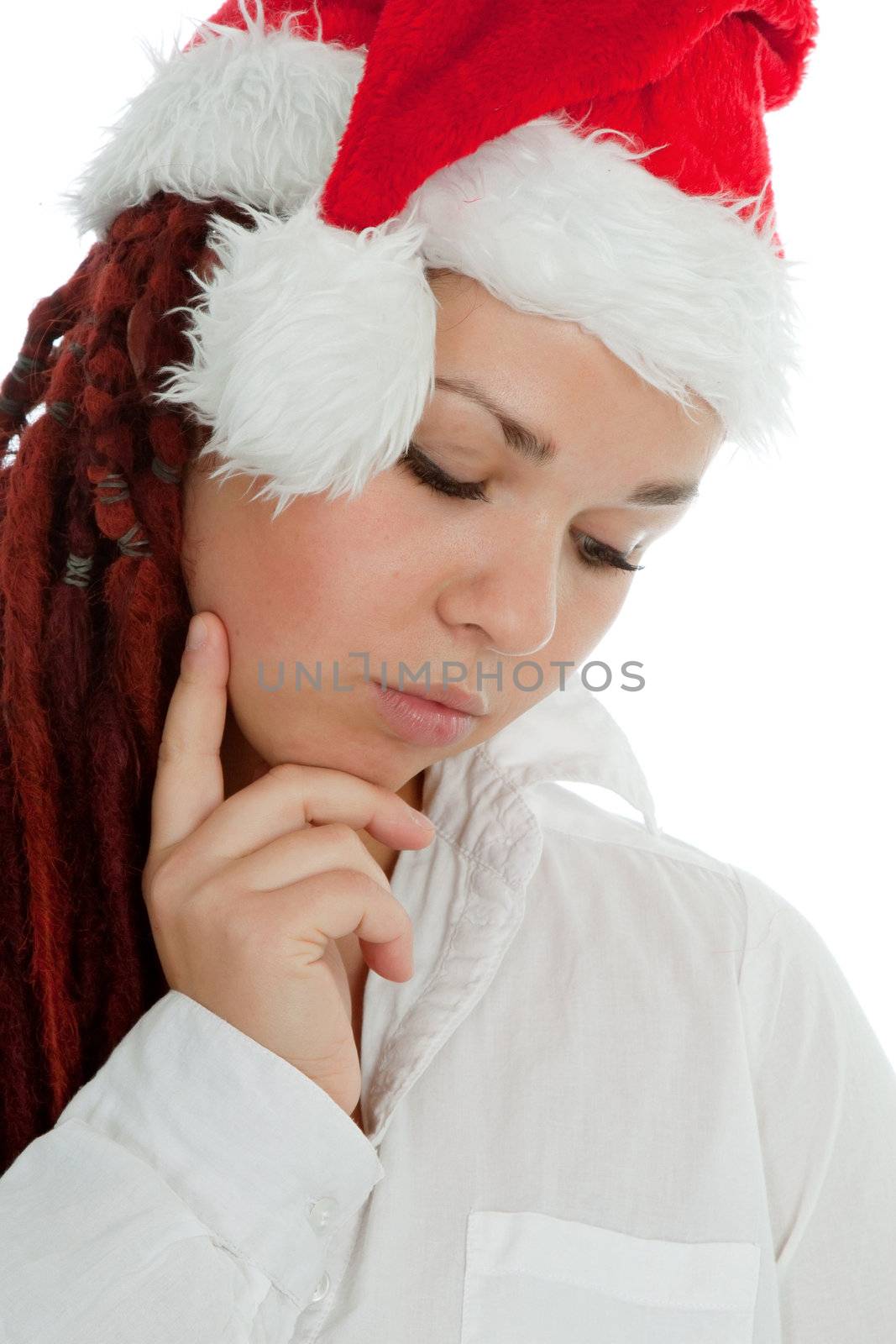 Portrait of young modern girl wearing Santa Claus hat isolated on white background.
