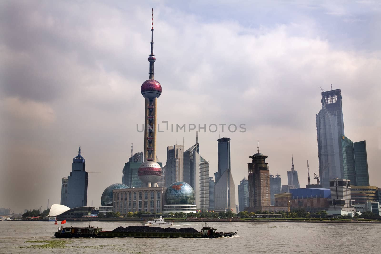 Shanghai Pudong Chna Skyline Daytime TV Tower with Coal Barge in front With Trademarks


