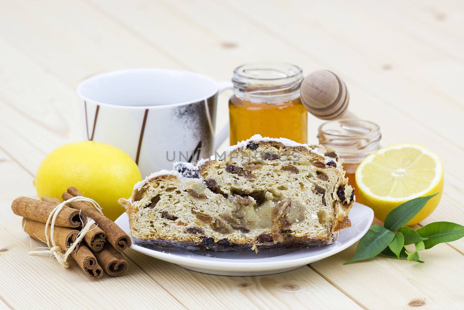 christmas stollen, honey, lemon and cinnamon sticks