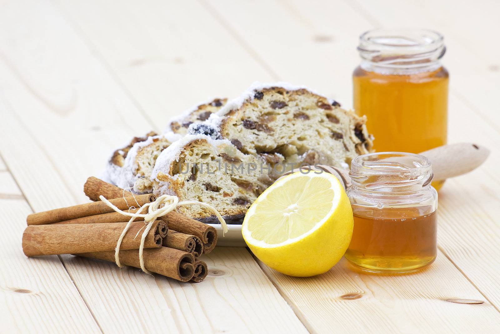 christmas stollen, honey, lemon and cinnamon sticks