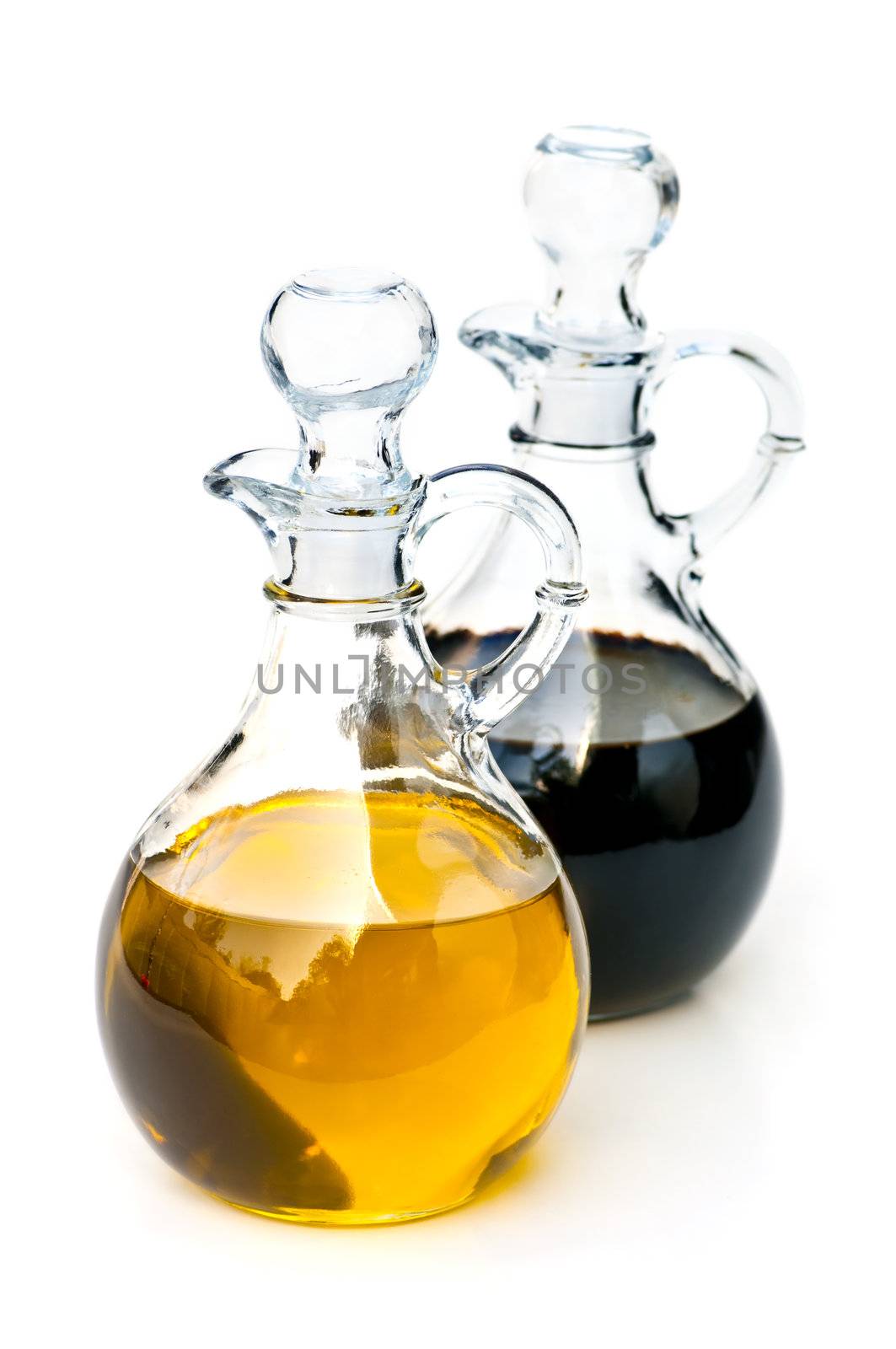 Oil and balsamic vinegar glass bottles isolated on white