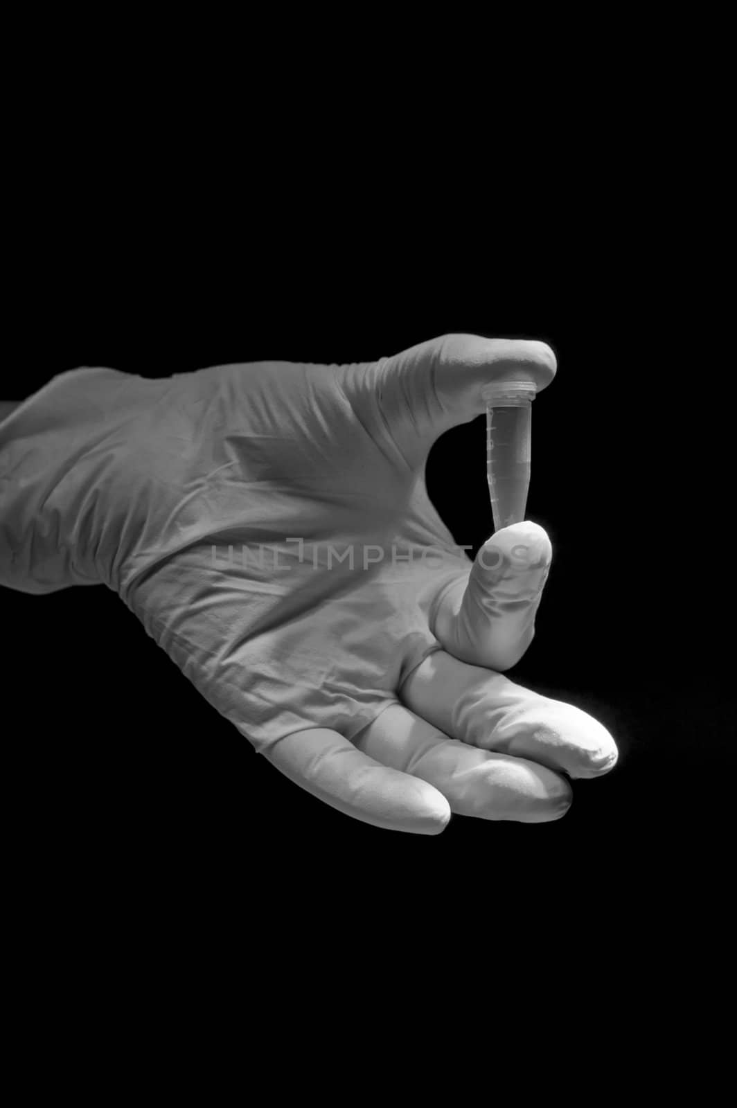 White and black picture of hand holding tube