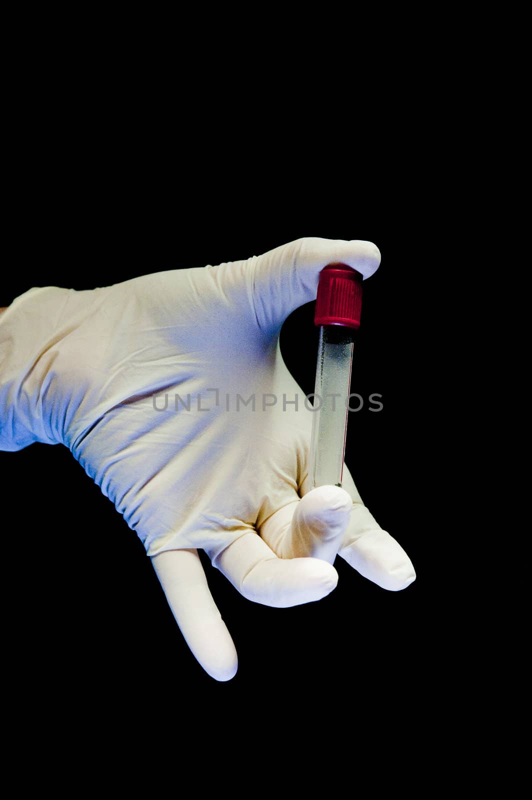 Hand covered in white glove holding test tube