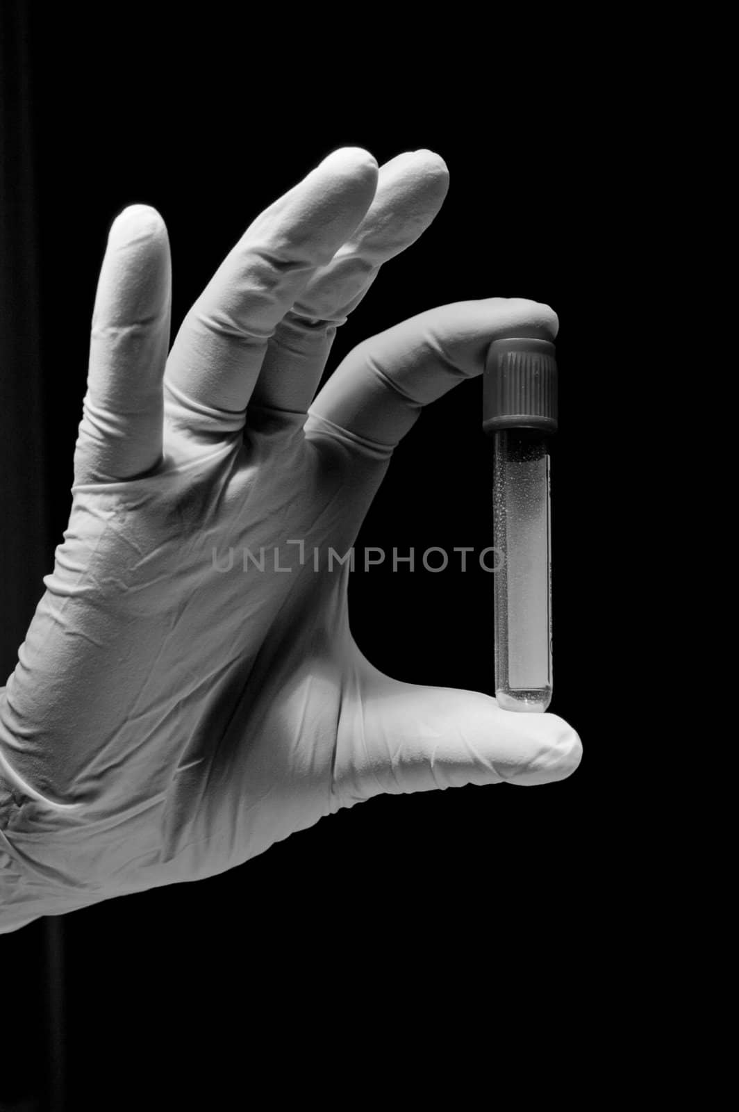 White and black picture of hand and tube