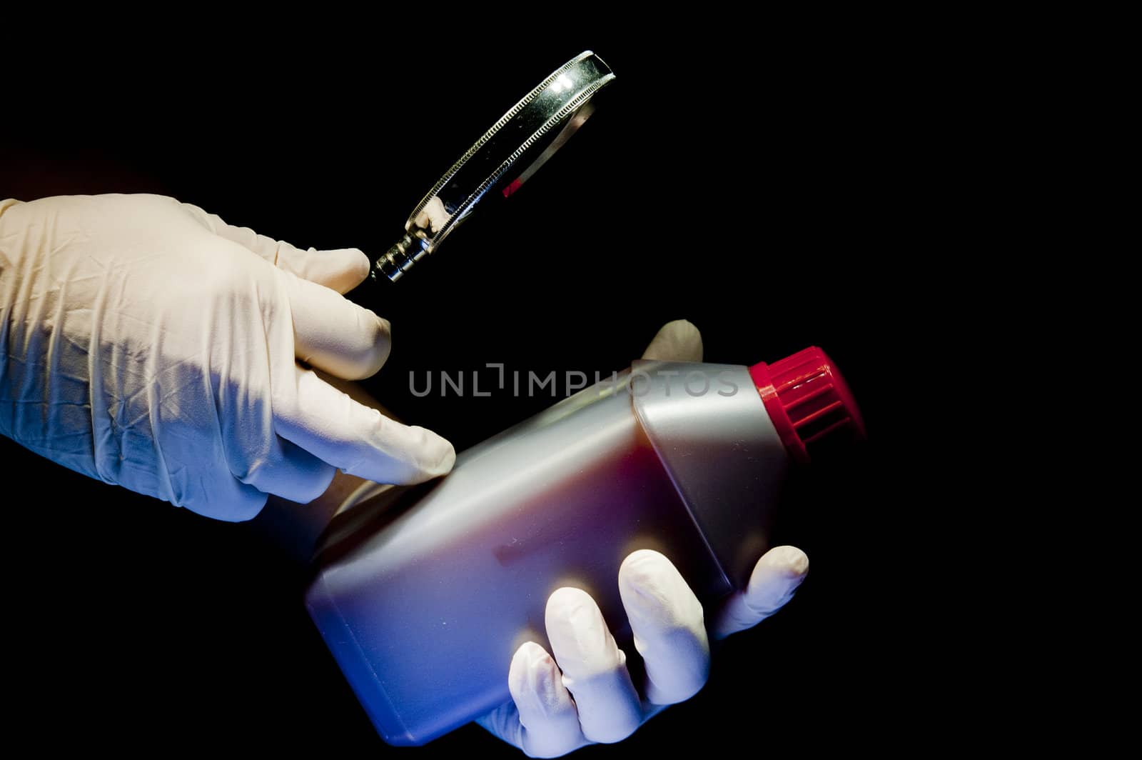 Two hands covered in white gloves and container