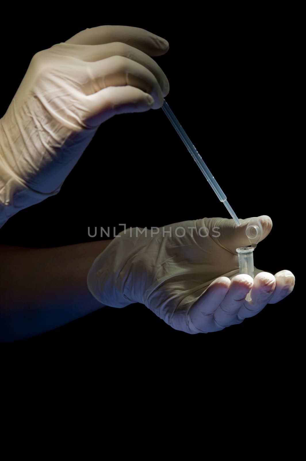 Hands in white gloves hold pipette and tube