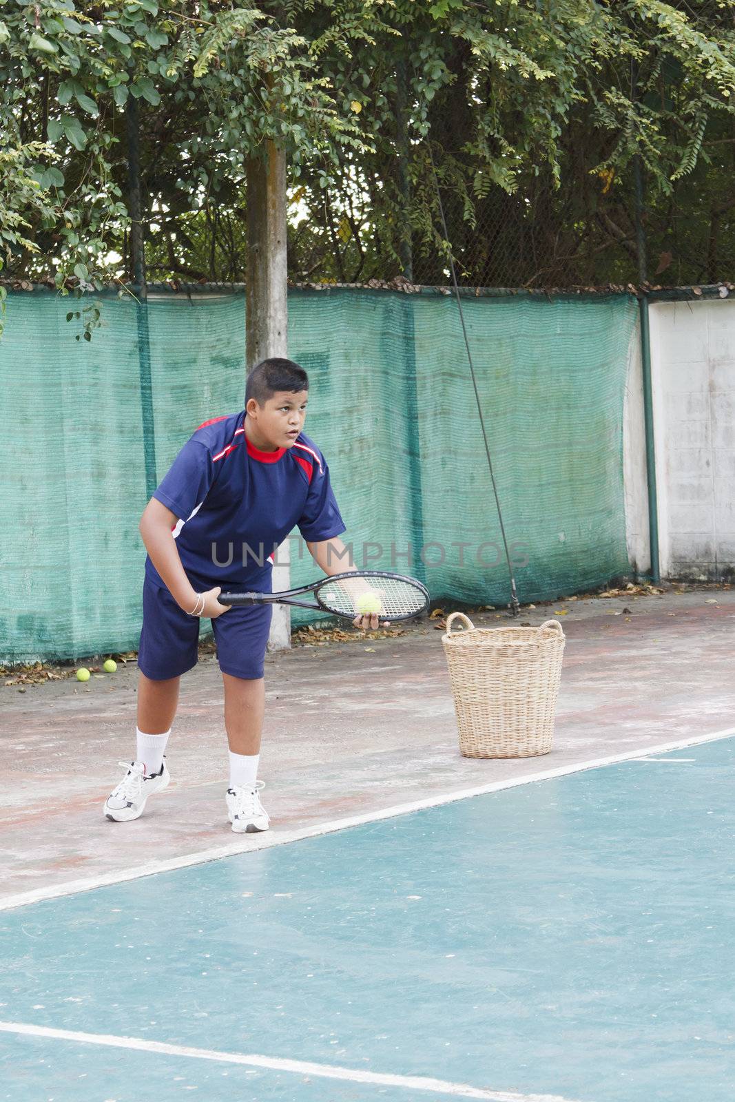 Thai boy tennis practicing