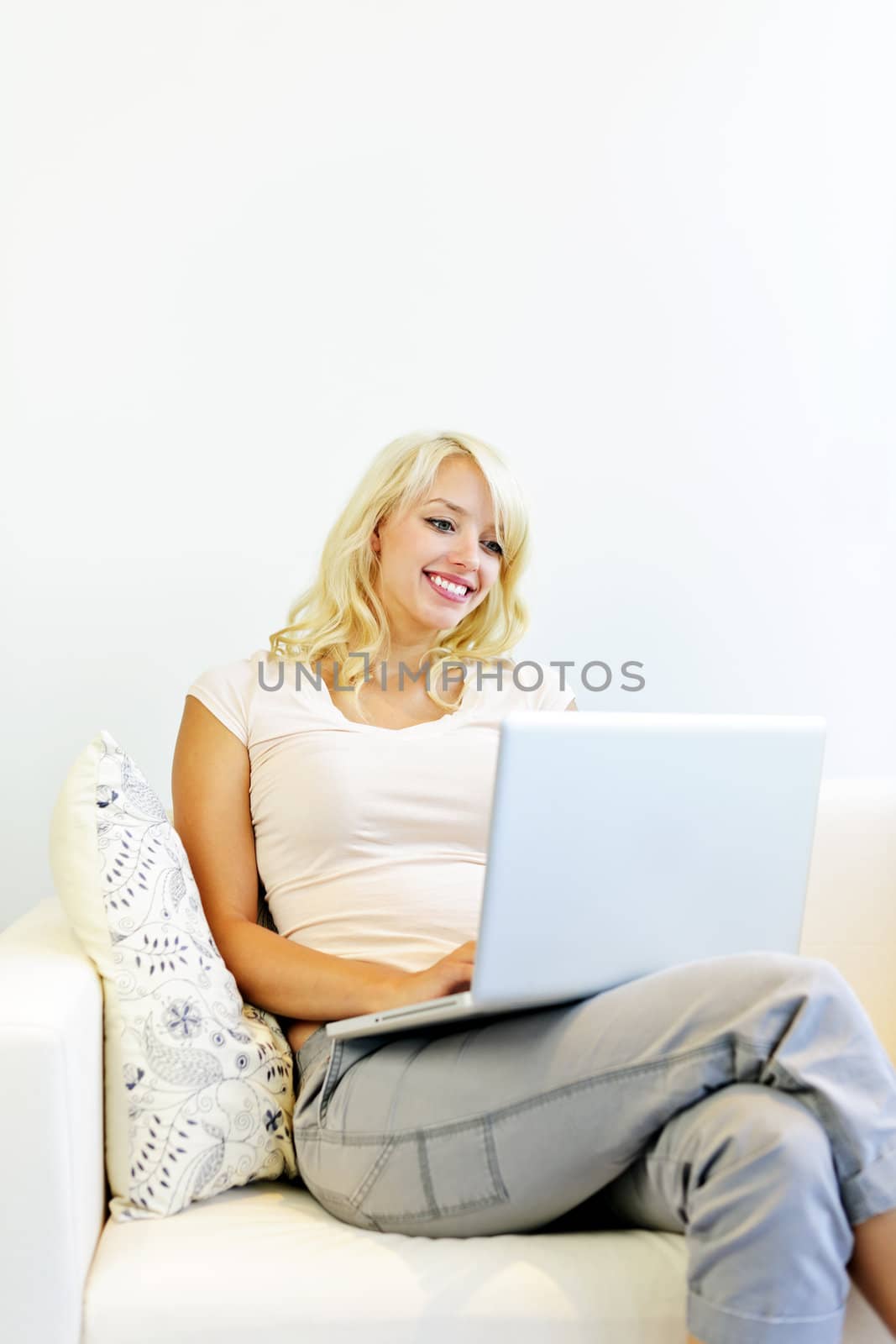 Young woman with computer at home by elenathewise