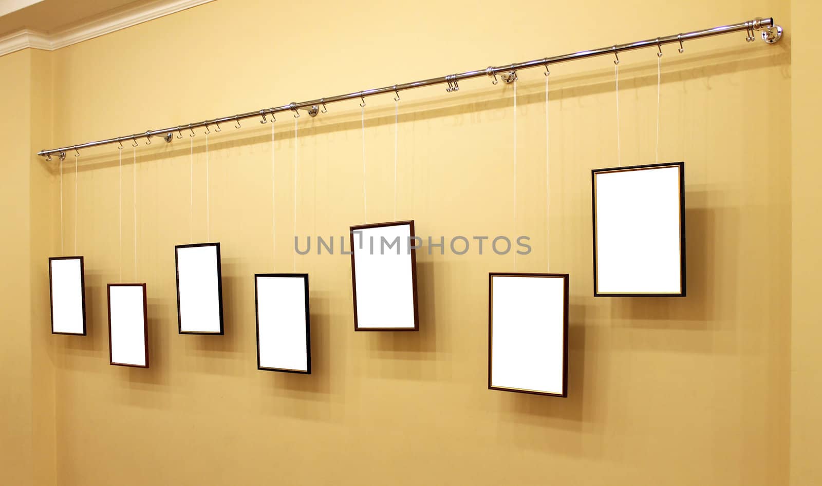 Seven frames with isolated canvas on the exhibition ledge by pt-home