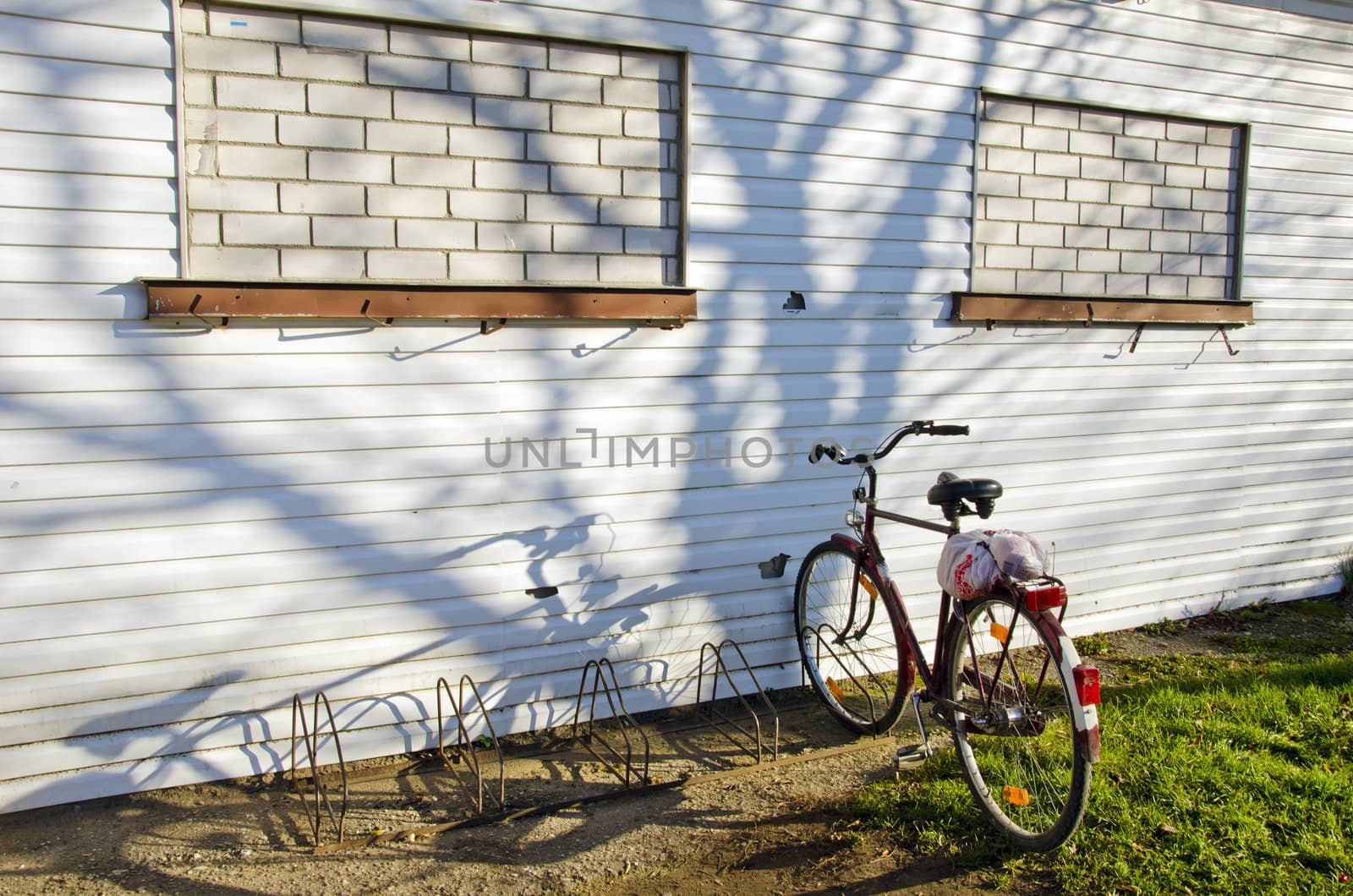 Bicycle parking place near building with windows mured up.