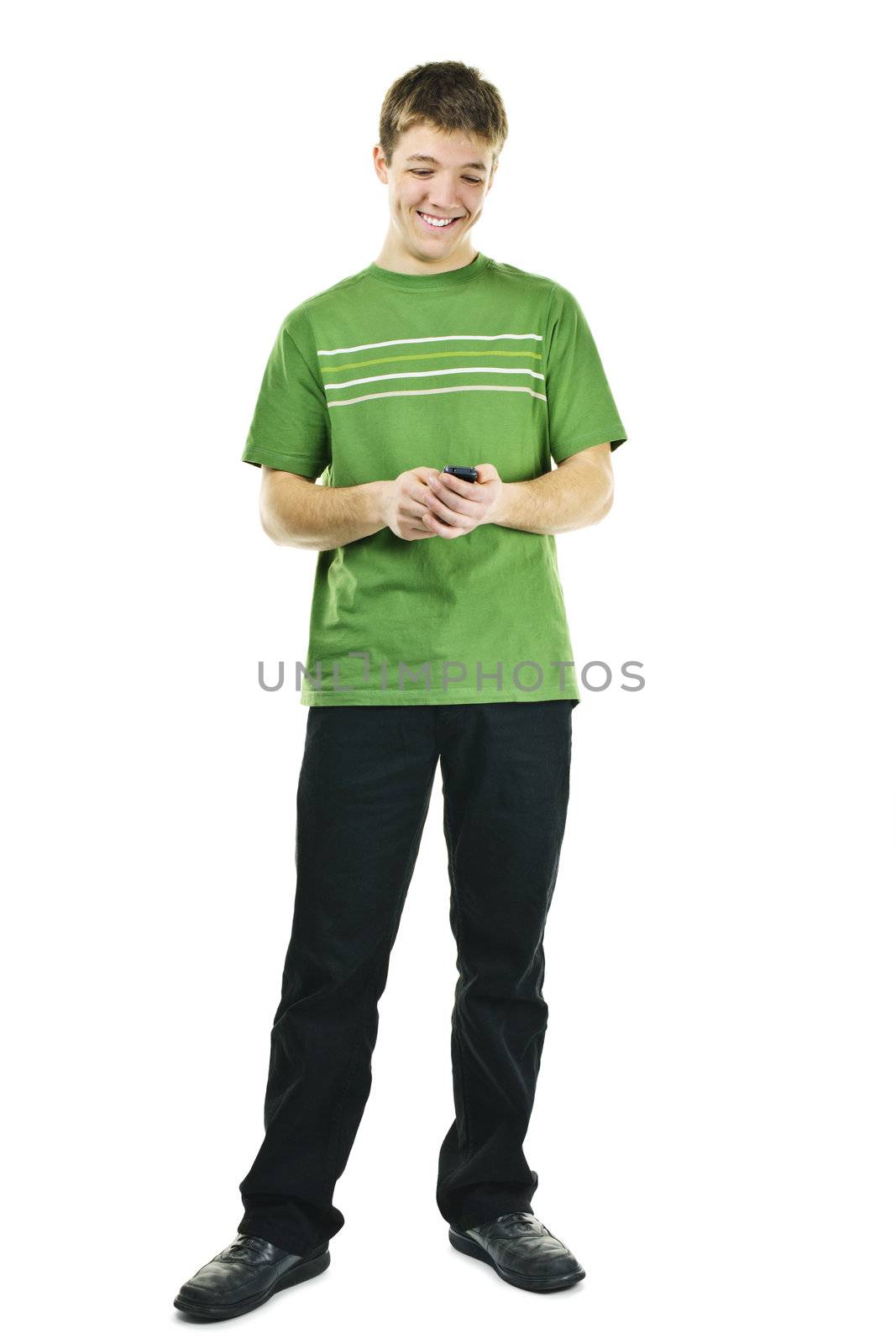 Happy young man texting on cellphone standing full body isolated on white background